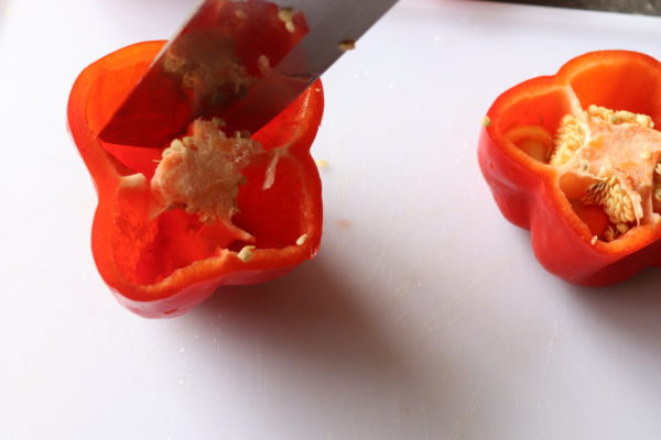 Red bell peppers being cut